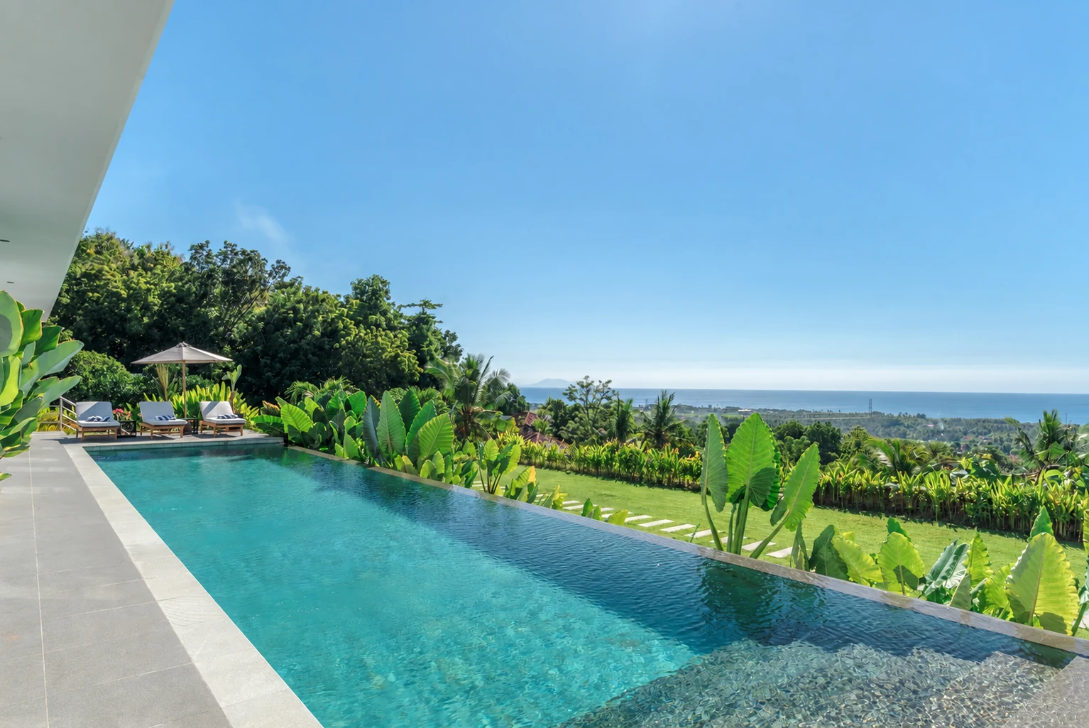 The infinity pool looking out over the tropical hillside to the sea.